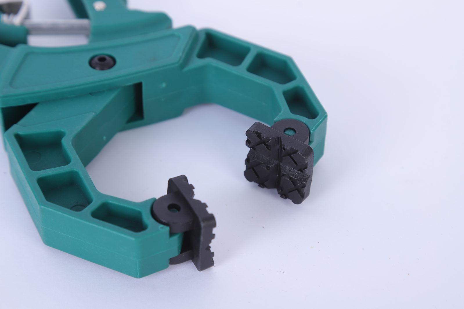 Close view of the rib-reinforced nylon body and swivel jaw pads on a Wildleg ratchet A-clamp.