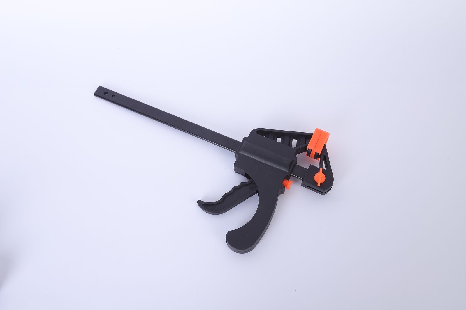A single Wildleg trigger bar clamp photographed from the side on a white background, showing the steel bar, nylon body and trigger handle.